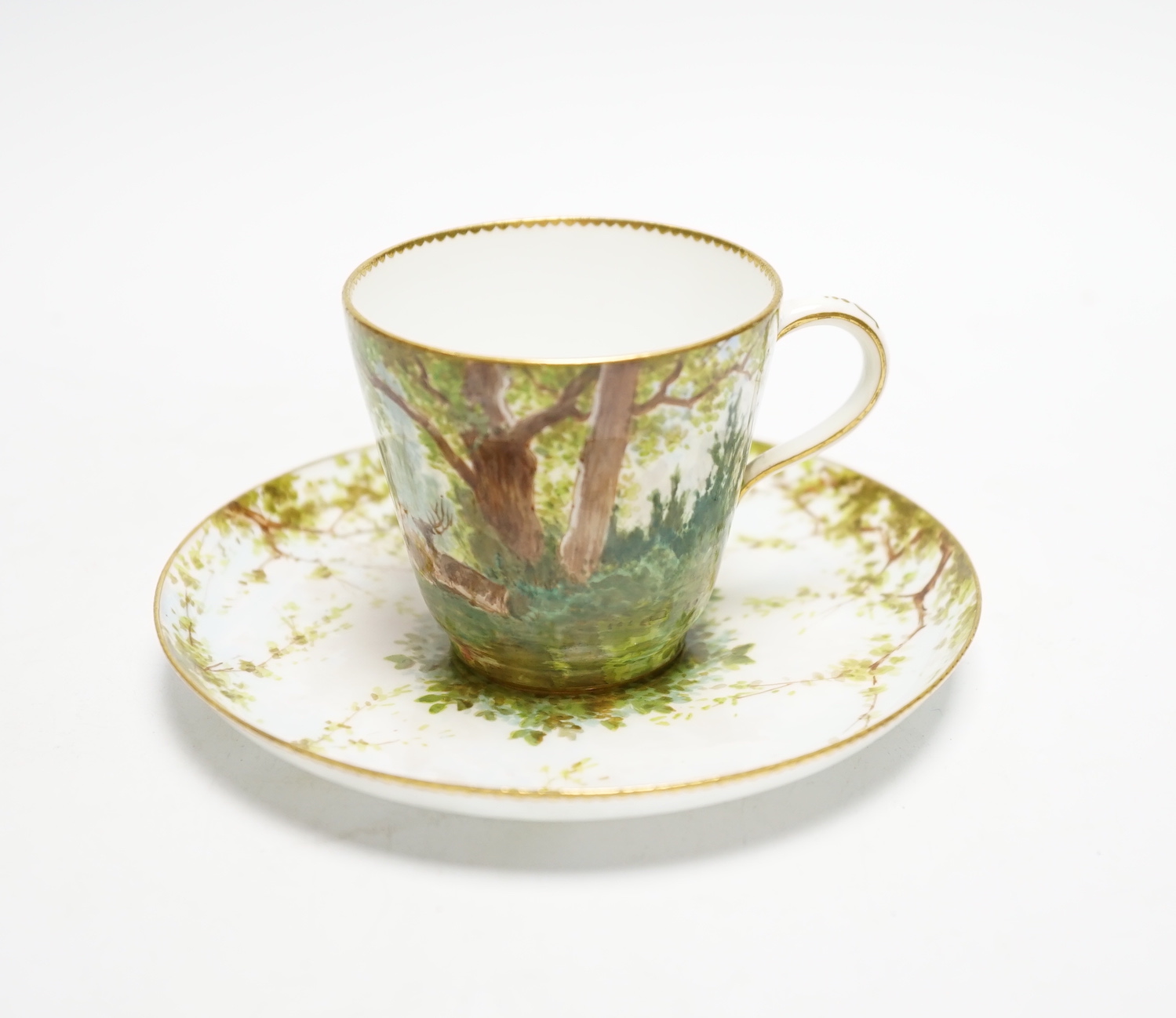 A Minton porcelain cup and saucer, painted with deer by Edouard Rischgitz